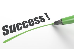 the word "Success!" being underlined with a green pen